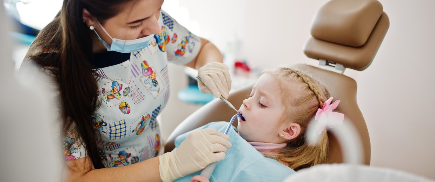Little baby girl at dentist chair. Children dental.