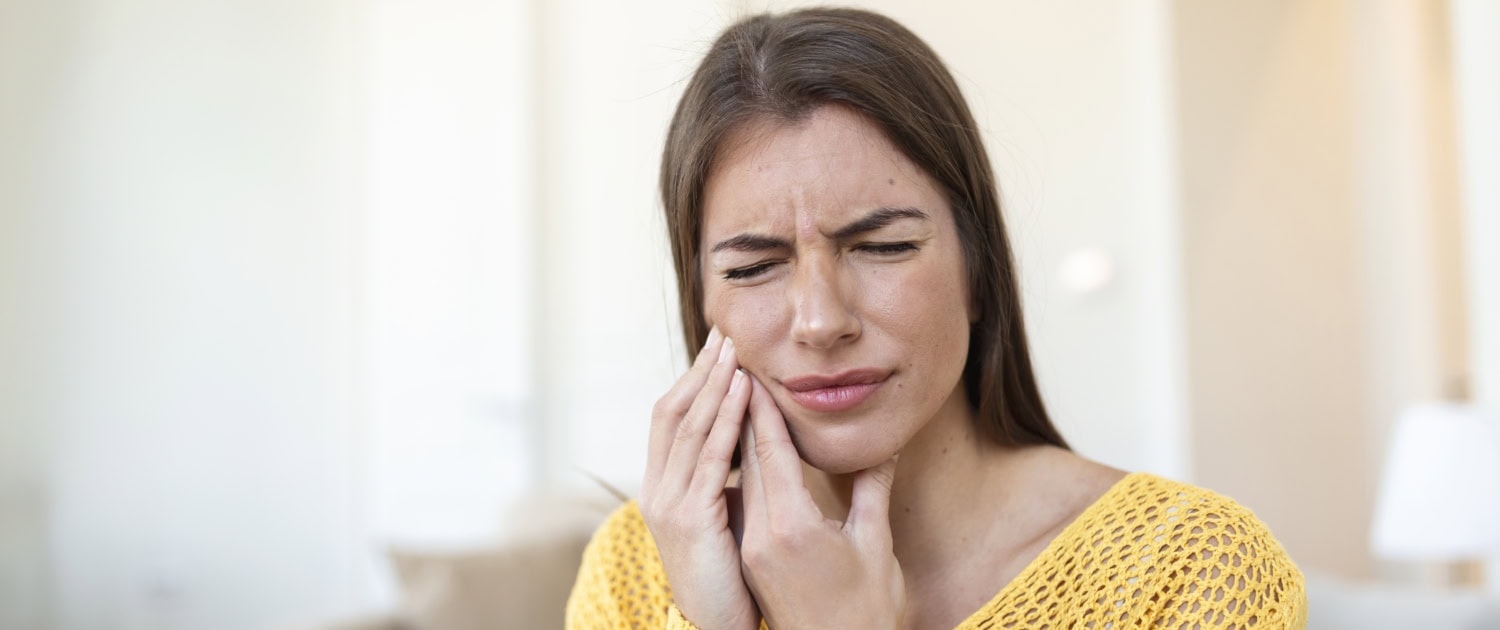 Tooth Pain And Dentistry. Beautiful Young Woman Suffering From Terrible Strong Teeth Pain, Touching Cheek With Hand. Female Feeling Painful Toothache. Dental Care And Health Concept. High Resolution